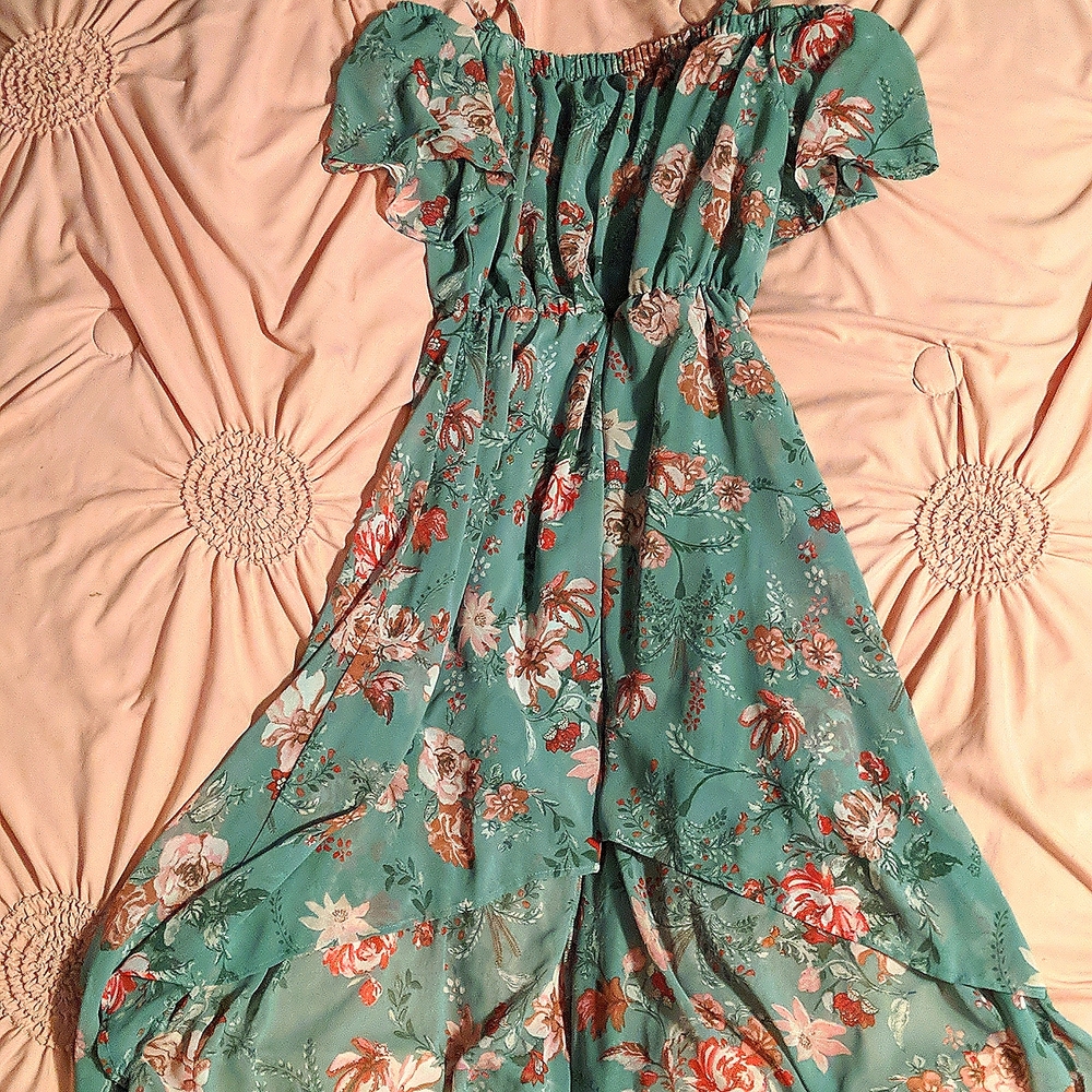 It is a mint green floral dress. Short in front long in the back. Size Small.